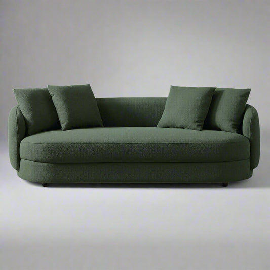 Green sofa with cushions on a white background