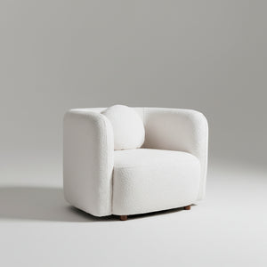 White armchair in a living room with wooden cabinet and window