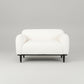 White armchair with black legs on a white background