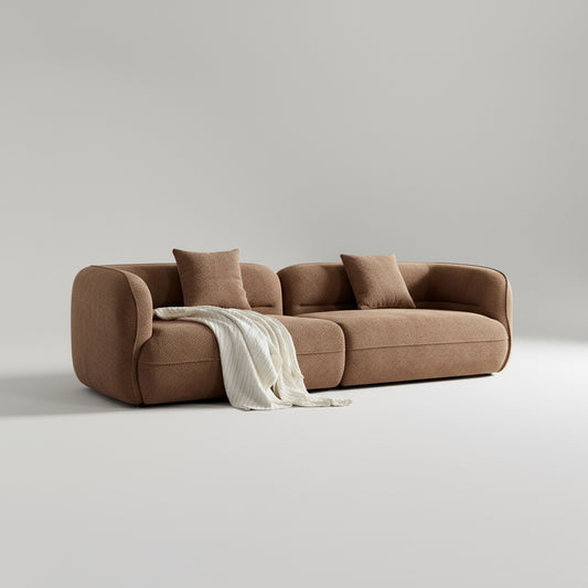 Brown sofa with two cushions and a blanket on a white background
