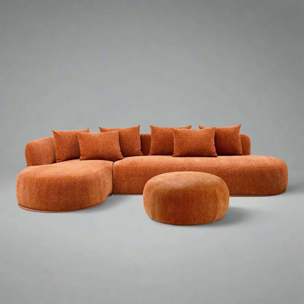 Orange sectional sofa with a matching ottoman on a white background