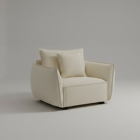 Beige armchair with cushions in a bright room with a window and curtains.