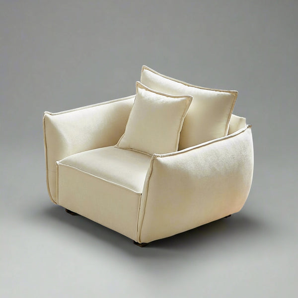 Beige armchair with cushions in a bright room with a window and curtains.