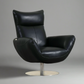 Black leather armchair with a metallic base on a gray background