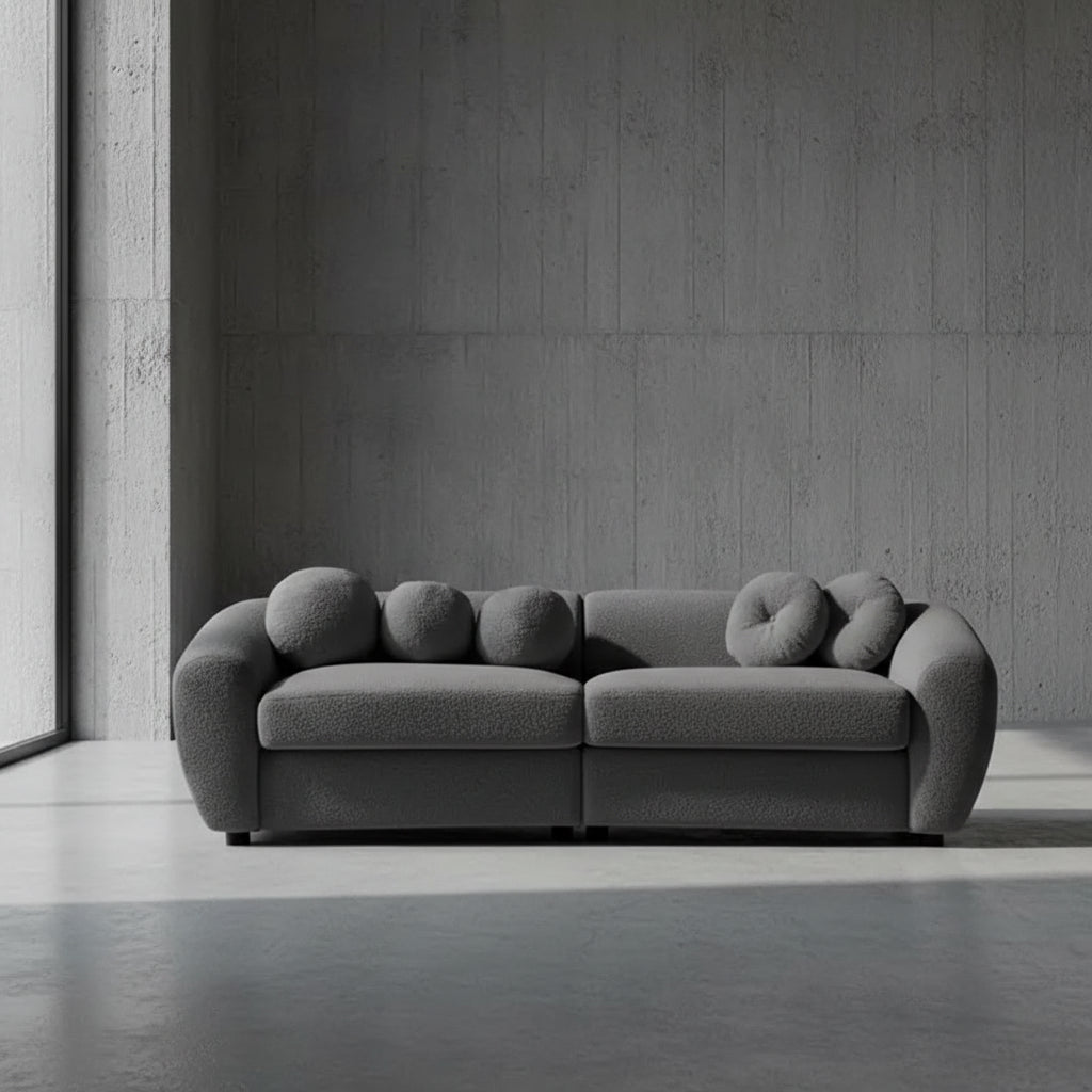 Gray sofa with unique circular backrests on a plain background
