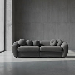 Gray sofa with unique circular backrests on a plain background