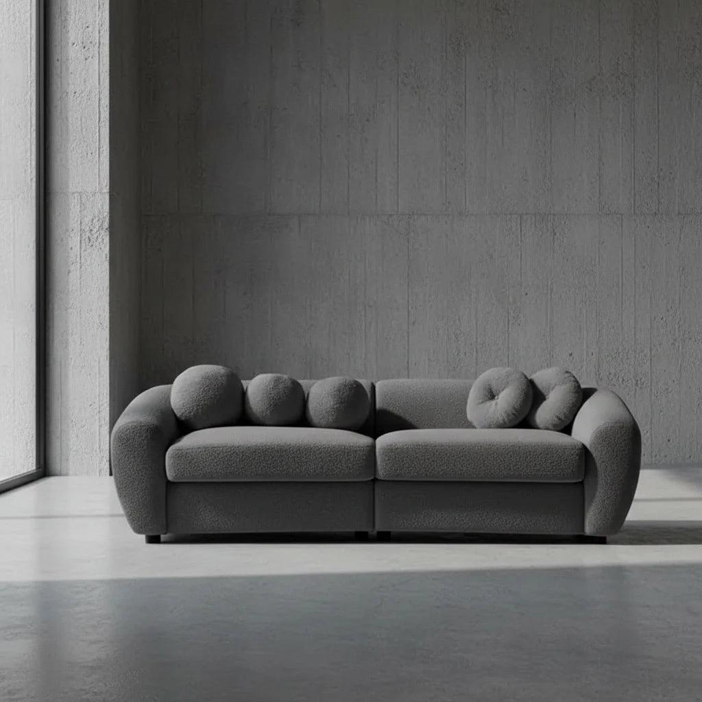 Gray sofa with unique circular backrests on a plain background