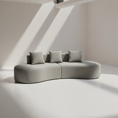Gray sofa with three cushions on a plain background