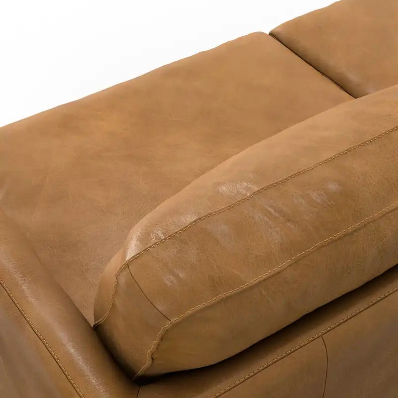 Close-up detail of the Livingston sofa's premium top-grain leather and tapered solid wood legs