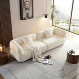 Modern living room with a white sofa, coffee table, and decorative items.
