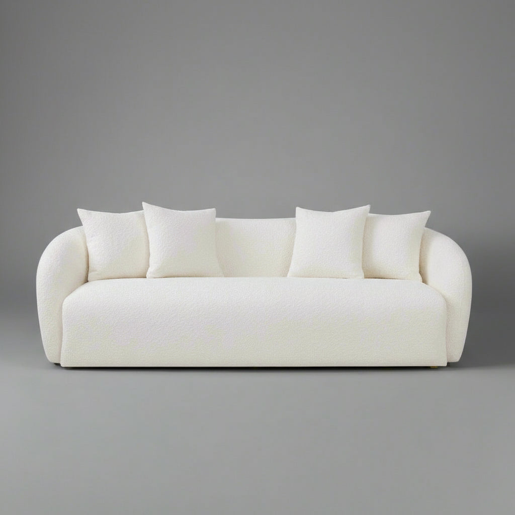 White sofa with four cushions on a white background