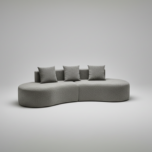 Modern living room with a gray sectional sofa, rug, and window view.