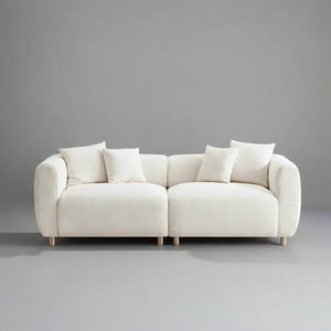Beige sofa with white cushions on a gray background