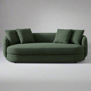 Green sofa with cushions on a white background