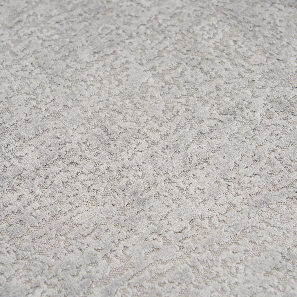 Extreme close-up of the premium Mist Grey chenille upholstery on THE ORVILLE sofa, showing the intricate woven texture and soft, durable fabric fibers.