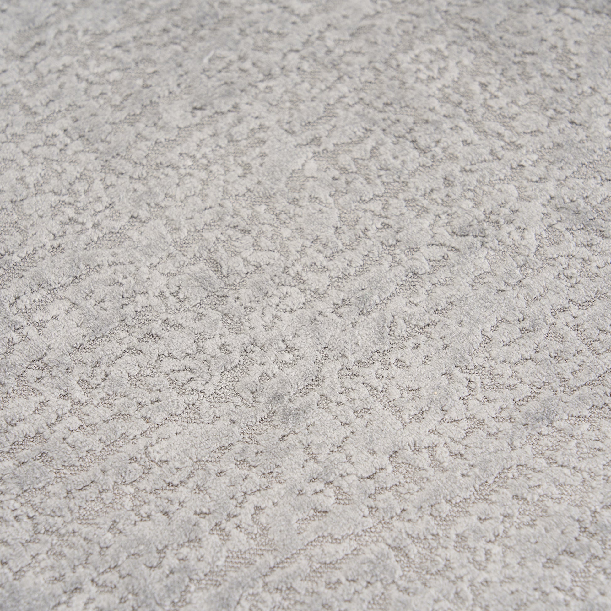 Extreme close-up of the premium Mist Grey chenille upholstery on THE ORVILLE sofa, showing the intricate woven texture and soft, durable fabric fibers.