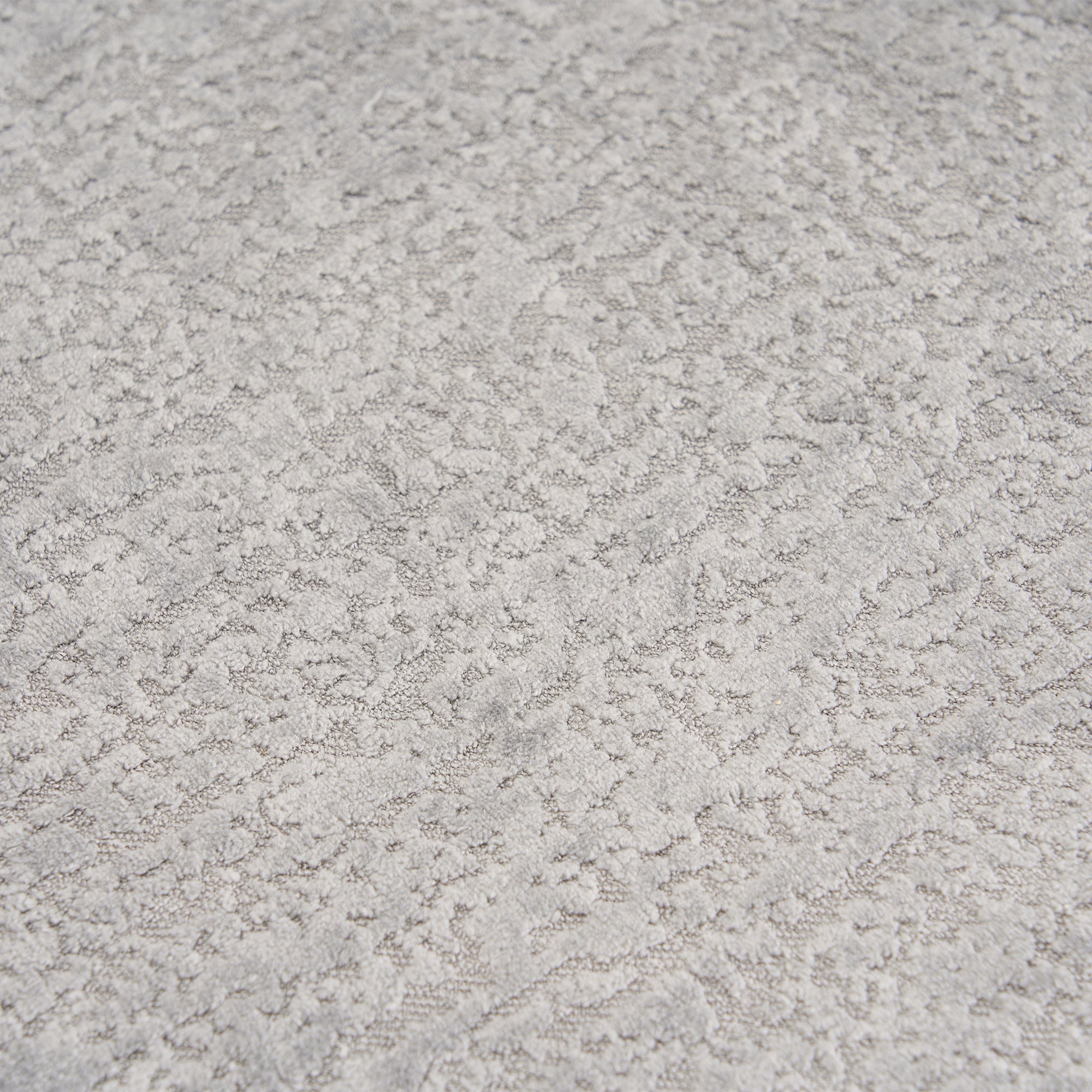 Extreme close-up of the premium Mist Grey chenille upholstery on THE ORVILLE sofa, showing the intricate woven texture and soft, durable fabric fibers.