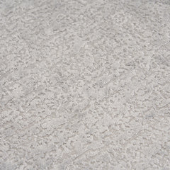 Extreme close-up of the premium Stone Grey chenille upholstery on THE ORVILLE sofa, showing the intricate woven texture and soft, durable fabric fibers.