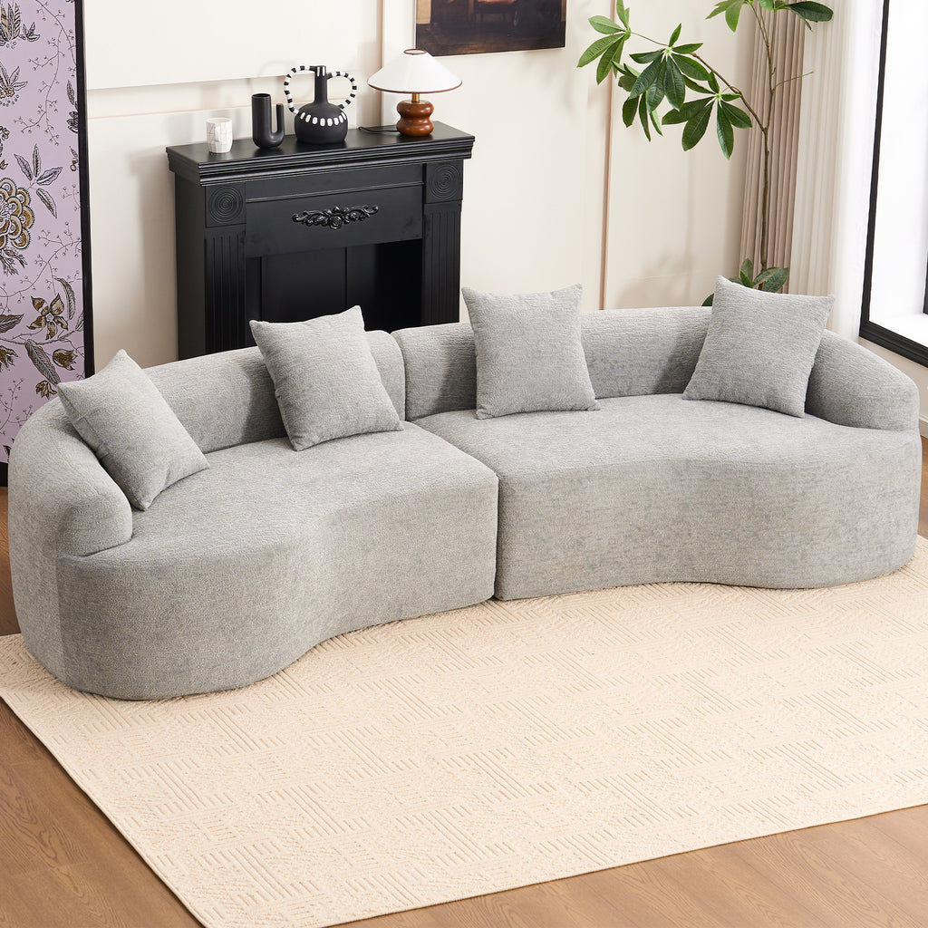 Large Mist Grey curved modular sofa with plush chenille upholstery and flared arms, styled in a modern minimalist living room.