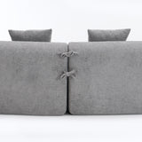 Close-up of the fabric connector ties on THE ORVILLE modular sectional, showing how the individual stone grey units securely attach to maintain the curved shape.