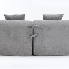 Close-up of the fabric connector ties on THE ORVILLE modular sectional, showing how the individual stone grey units securely attach to maintain the curved shape.